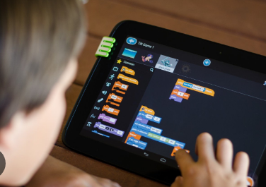 Hands using a tablet during a practical technology activity